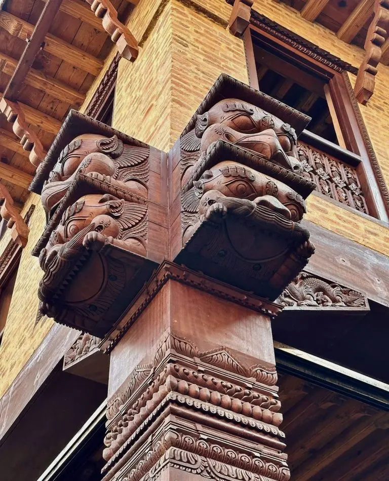 Carved Newari wooden column at the corner of the heritage building