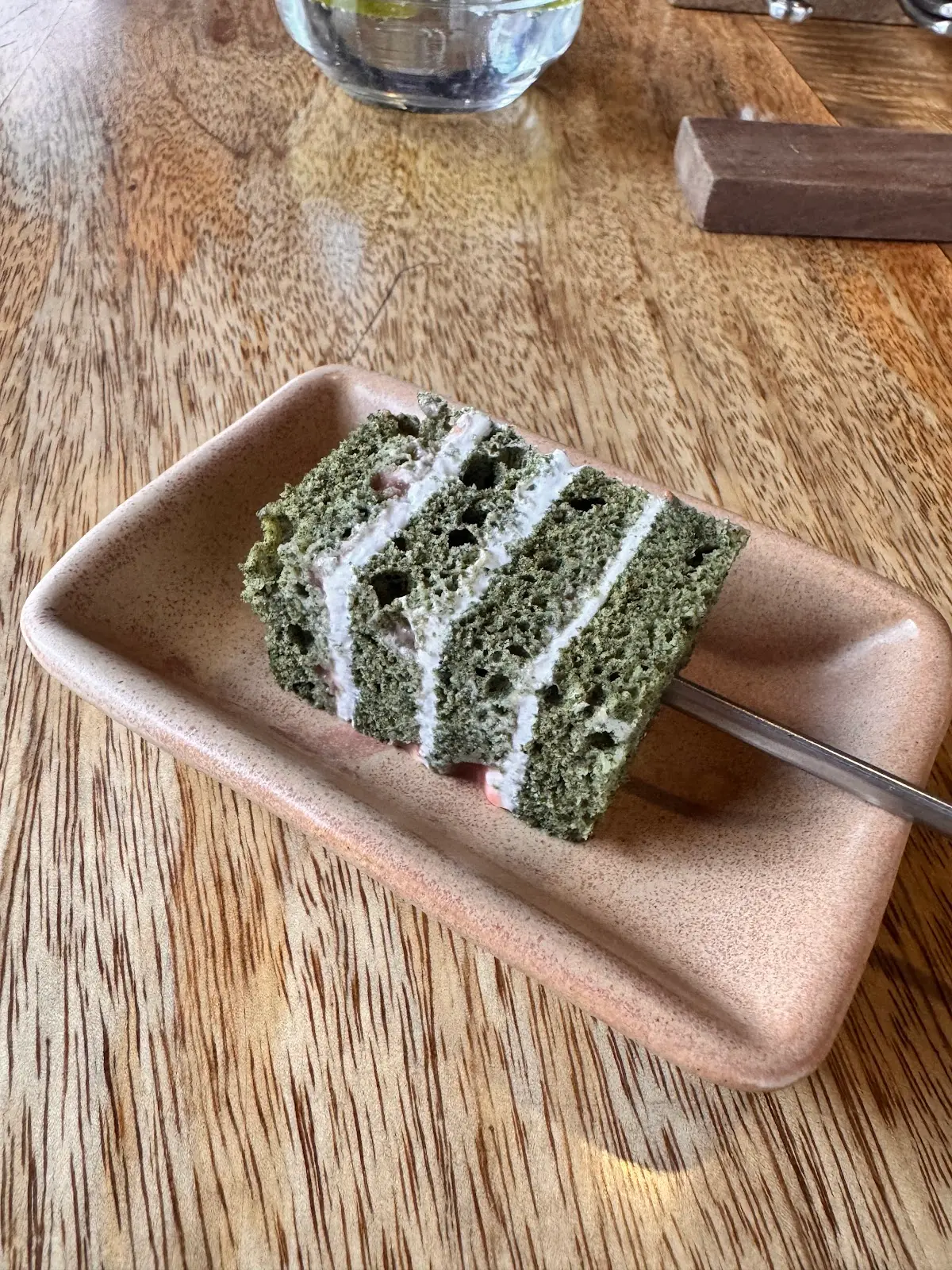 Slice of fermented millet bread on a hand-thrown clay plate